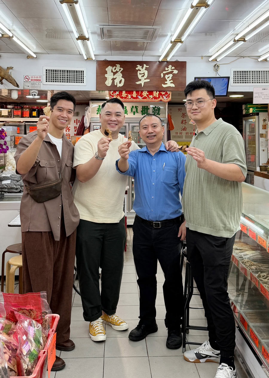 Chinese Restaurant Awards Celebration Group of four men celebrating at a Chinese restaurant, holding traditional snacks.