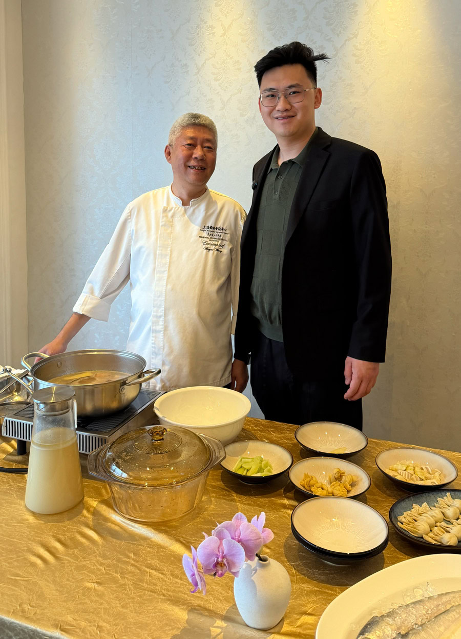 Chinese Restaurant Awards Celebration Chef and guest at Chinese Restaurant Awards event with dishes on table.