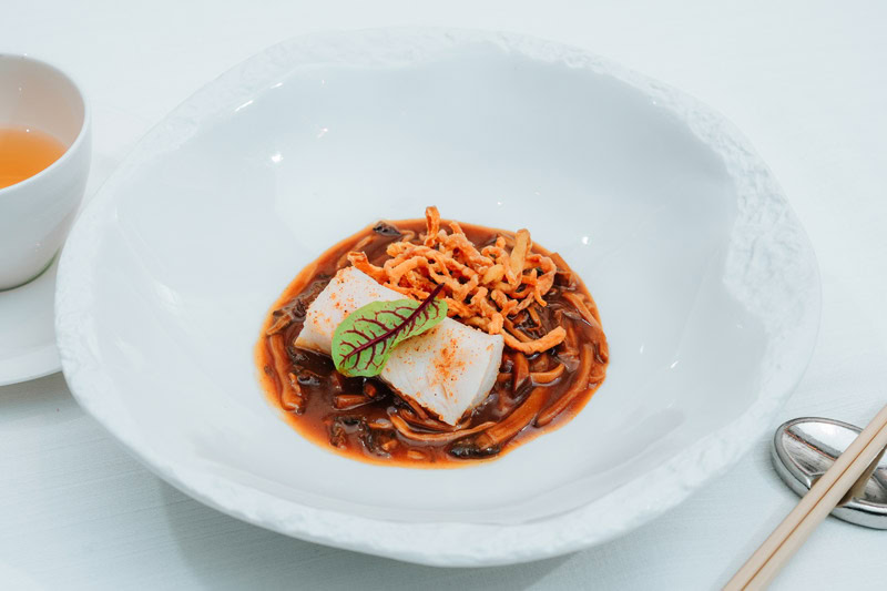 Elegant Chinese Noodle Dish Delicious Chinese noodle dish with vegetables and tofu in a white bowl.
