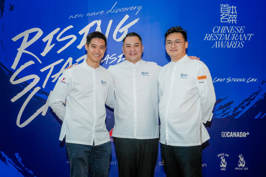 Chinese Restaurant Awards Ceremony Three chefs in white uniforms at Chinese Restaurant Awards event.