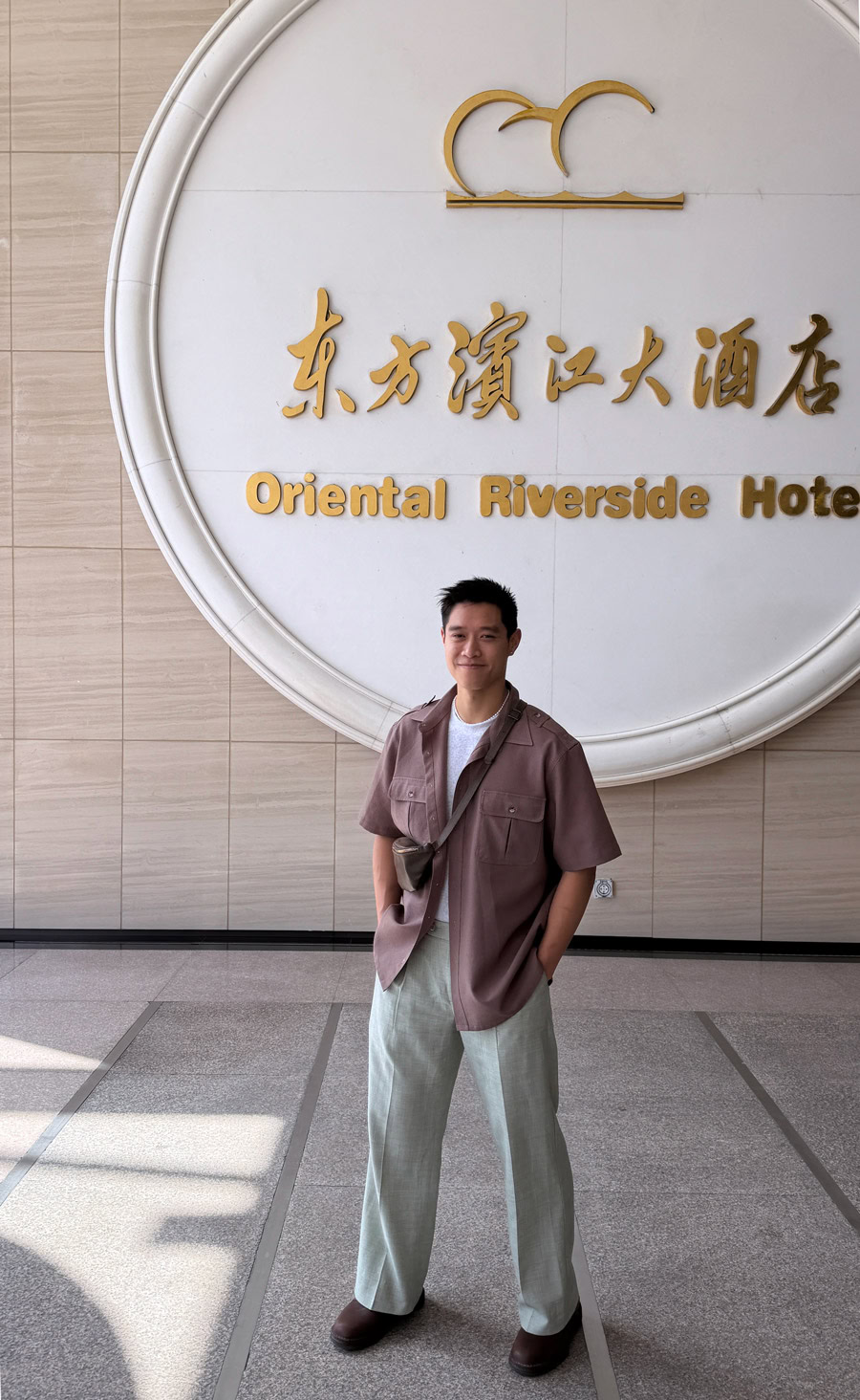 Oriental Riverside Hotel Entrance Young man standing in front of Oriental Riverside Hotel entrance.