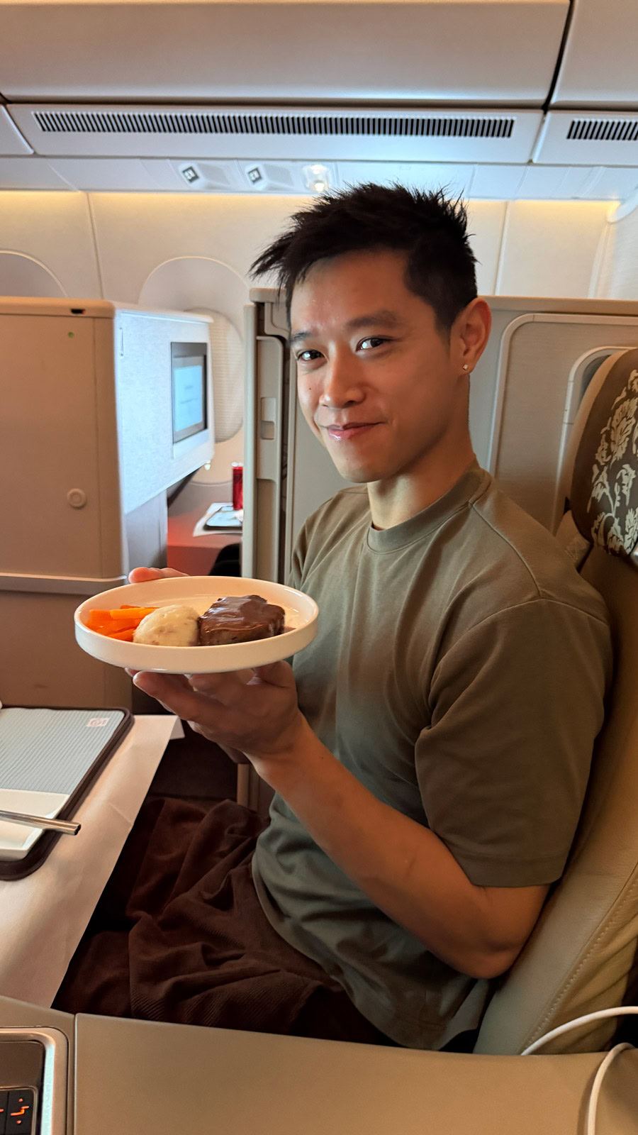 Chinese Restaurant Awards Celebration Young man enjoying dessert on a flight, celebrating Chinese cuisine awards.