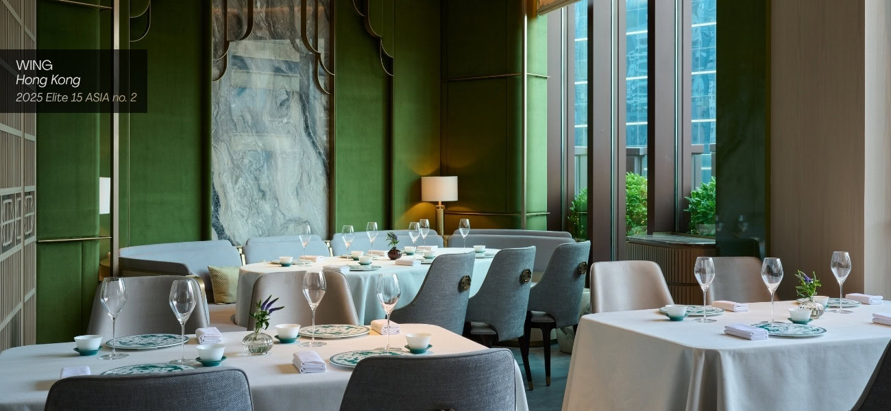 Modern Chinese restaurant interior with green walls and large windows.